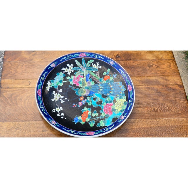Bring vibrant color and exotic elegance to your collection with this striking vintage decorative porcelain charger plate....