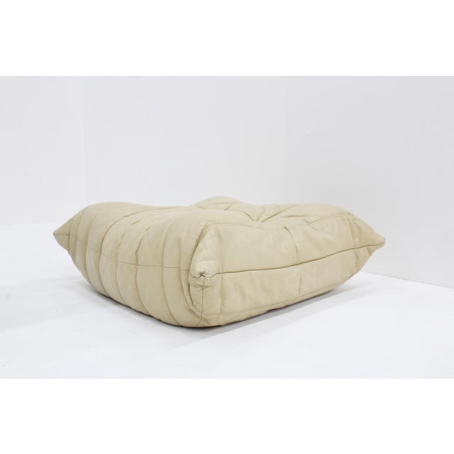 Original Togo beige leather ottoman by Ligne Roset designed by Michel Ducaroy. This is an original togo ottoman in high...