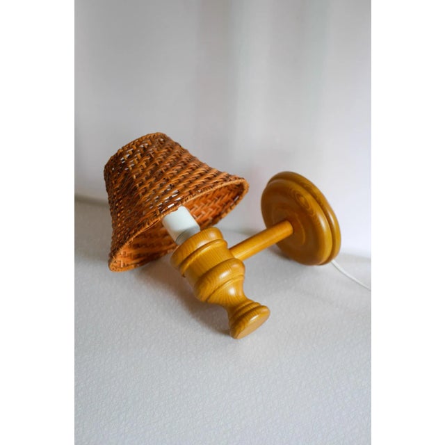 Rustic and substantial, wooden sconce with a rattan lampshade, which was crafted from solid pine from Ikea, Sweden. This...