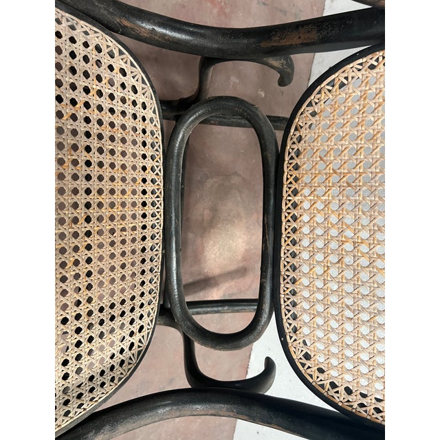 Rocking chair in bent and stained wood Seat and back with cane seat Good condition Dimensions: H 100 x W 110 x D 55 cm...