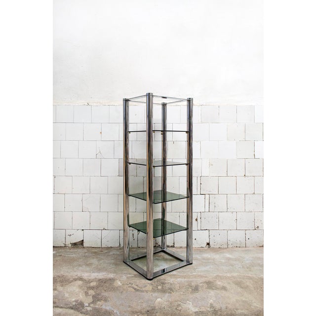 Self-supporting bookcase with chromed steel structure and smoked glass shelves. Italian production 70s