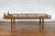 A Chinese Qing Dynasty period elm wood daybed from the 19th century, with carved foo dog guardian lions, bamboo slats and...