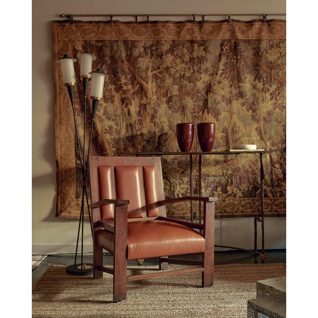 A 1950s Italian three-arm floor lamp in blackened metal, produced in the distinctive spirit of Stilnovo. Each conical arm...