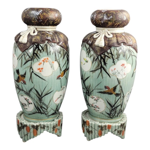 This extraordinary pair of vases represents a pinnacle of Japanese ceramic engineering from the Golden Age of the Meiji...