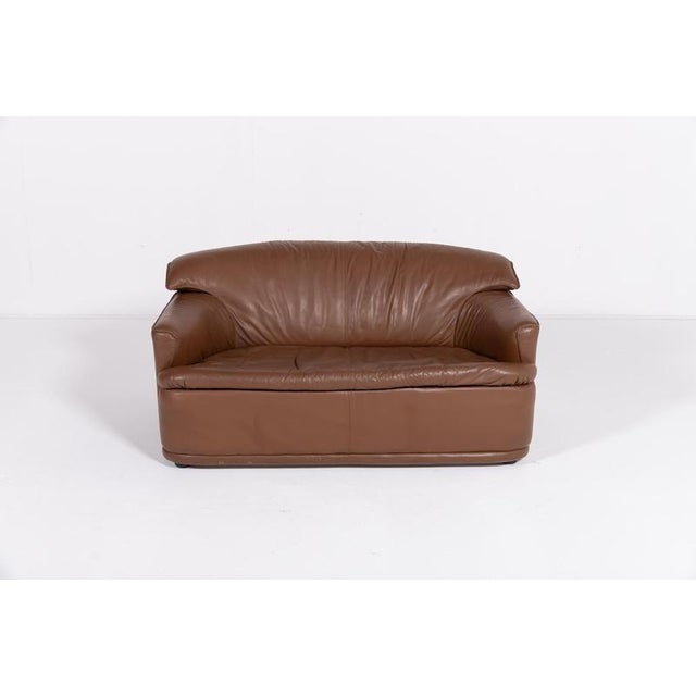 Sculptural 2-seats sofa/loveseat in brown leather, produced in Italy 1980’s.Condition Good, usage marks and patina. I have...