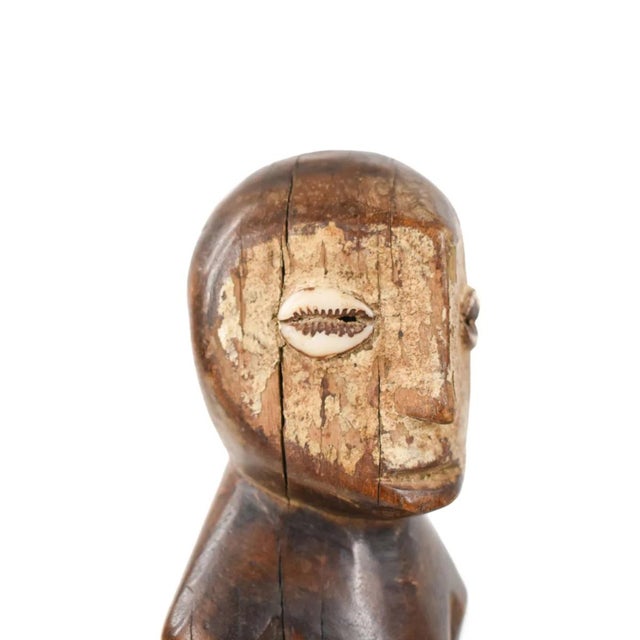 Lega sculptures are usually carved in a highly distinctive style, with a heart-shaped concave face with a slightly bulging...