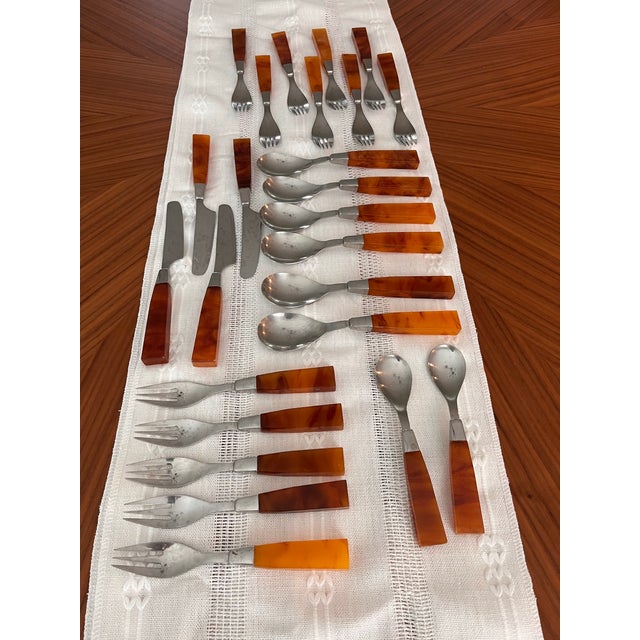 Mid-century faux tortoise and Bakelite/resin and stainless flatware made in Japan by Supreme Cutlery. Perfect for a mid-...