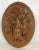 Large black forest style plaster plaque with a hare surrounded by oak leaves. Circa 1920.