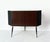An elegant 1950s bar cabinet made of wood and formica on the outside. Inside, it features a unique rotating storage...