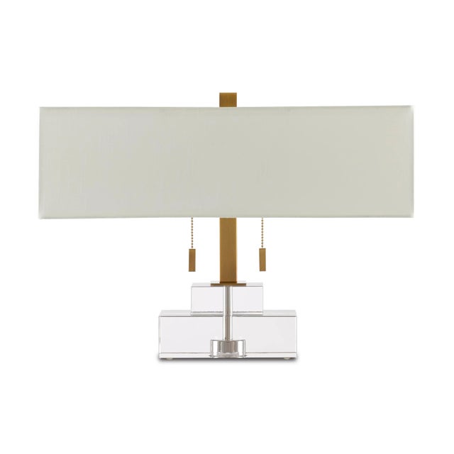 Rectangles of clear optic crystal make the Chiara Table Lamp luminous. Contrasting the pale stacked body are the antique...