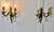 A pair of French Brass Twin Wall Lights The lights are in the classical style, hung with crystal lustres, they are in...