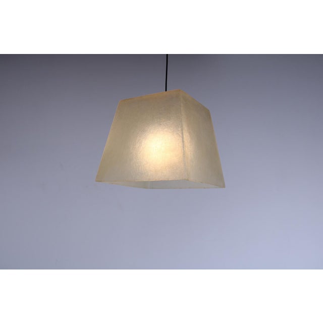 Characteristic hanging light by Roche Bobois, made of fiberglass looking resin. Brings poetic diffused light through the...
