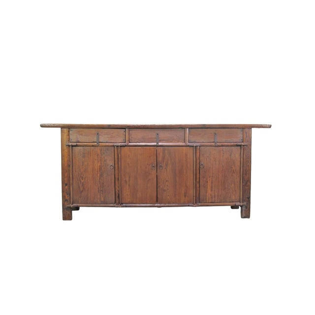 This 19th century sideboard was handmade from sturdy elm. Features a 3 door opening and 2 inner long shelves for simple,...