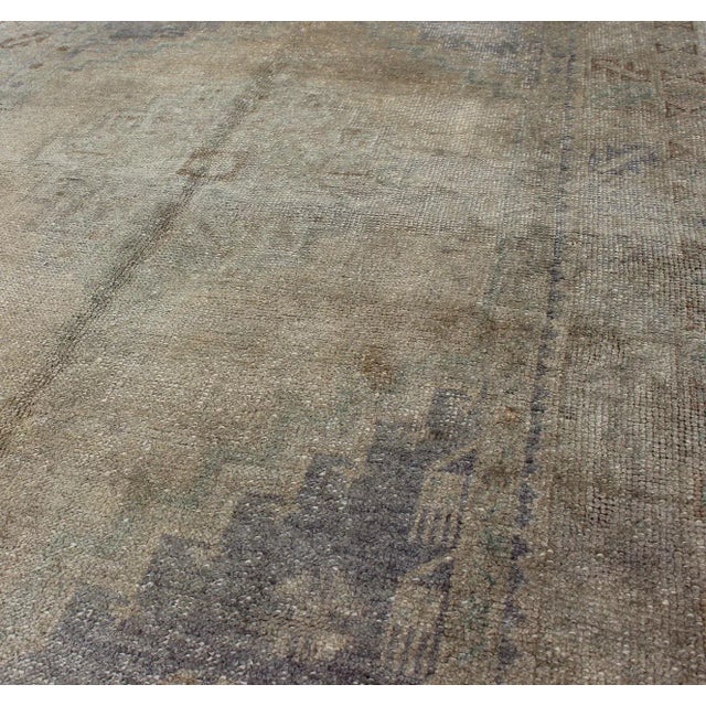 Mid 20th Century Vintage Turkish Oushak Rug With Muted Colors and Central Medallion Design For Sale - Image 5 of 7