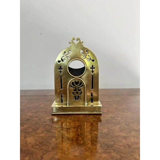 Antique Edwardian brass pocket watch holder having a brass antique Edwardian pocket watch holder with cross detail. D. 1900