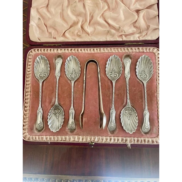 Set of quality antique Victorian solid silver spoons and sugar tongs in their original leather box opening to reveal a set...