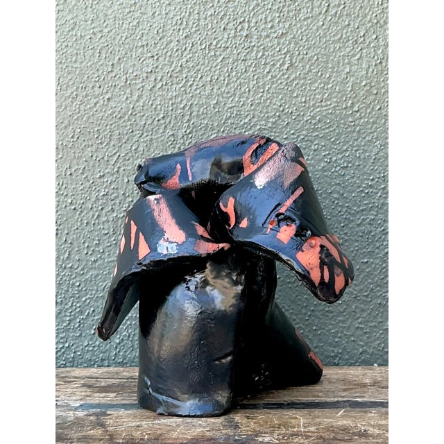 Showcasing dynamic sculptural form, this hand-formed ceramic abstract sculpture features folded, drapery-like folds and...