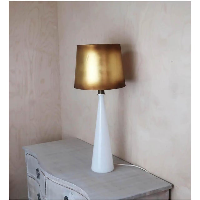 Original gold coloured shade. Wired to UK standards This piece is attributed to the mentioned designer/maker. It has no...