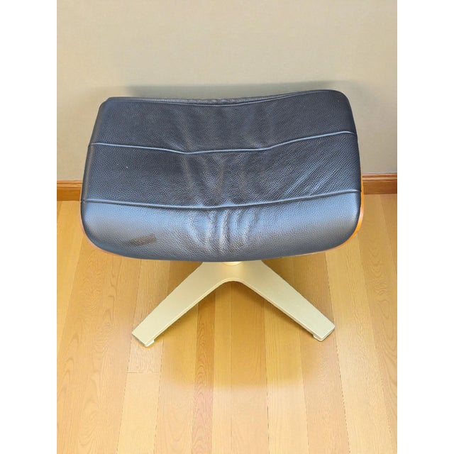 The Danish Modern Swivel Stool in black leatherette with a metal base and wood ply craft is a sleek and stylish piece of...