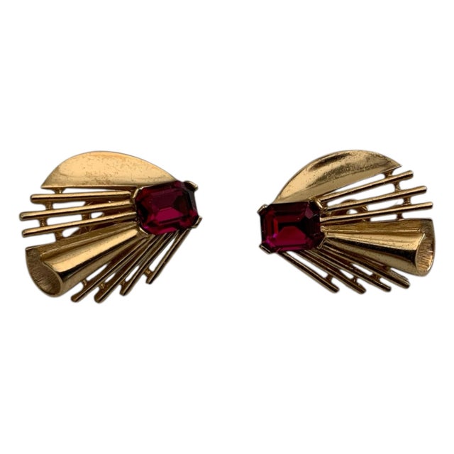 This is a vintage Crown Trifari gold-tone ruby red crystal starburst clip-on earring Trifari is a highly regarded name in...