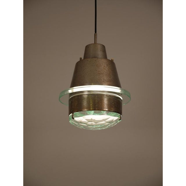Rare Stilnovo pendant similar in style to Fontana Arte pendant lights of the same period. Faceted glass, nickelled and...