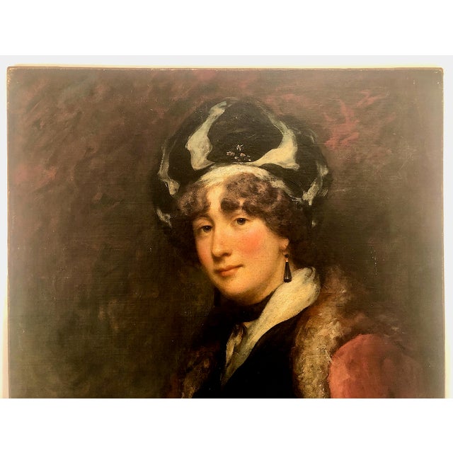 This painting is an authentic early 19th-century portrait of a lady categorized under the British School. It offers a...