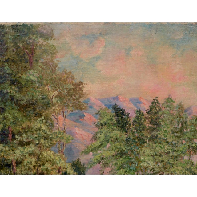 Vintage 1920's California landscape of a path through tall evergreen trees with the grand Sierra mountains in the...
