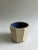 Handmade ceramic cup with blue glazed interior.