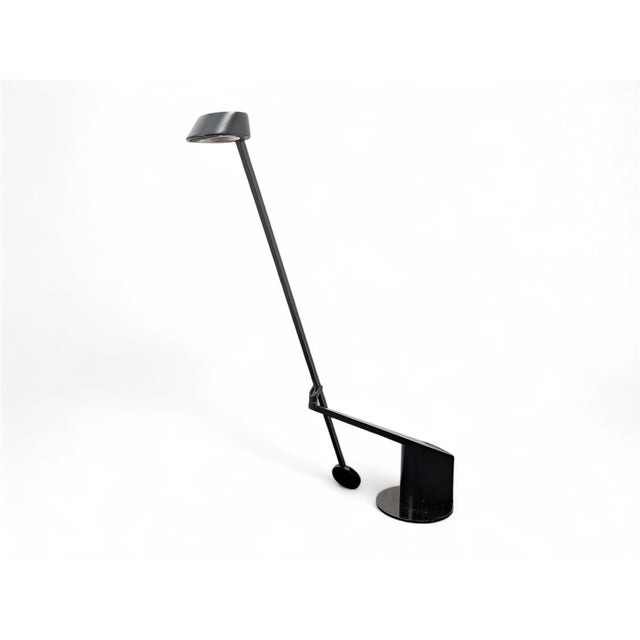 The table lamp shown in the image is the "Ala" model, an icon of Italian design. It was designed by Rodolfo Bonetto and...