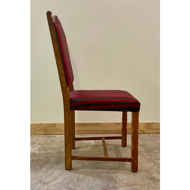 Oak dining chairs with green striped wool upholstery, in the style of Henning Kjaernulf. Brass tack accents. Unsigned