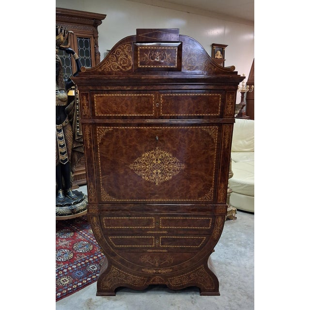 A spectacular "tulip" secretary desk with a richly inlaid drop-front, remarkable for both its proportions and the...