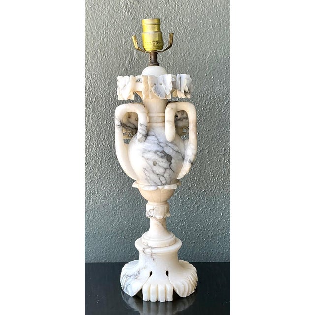 This vintage carved alabaster table lamp embodies the timeless elegance of Neoclassical design, showcasing exceptional...