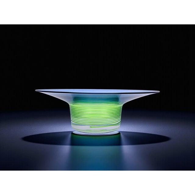 Add a touch of contemporary elegance to your home with this unique piece. Light passes through the blue and green glass...