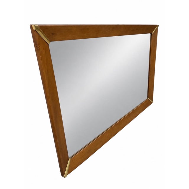Make a bold statement with this large Mid-Century Modern walnut and brass wall mirror, circa 1960s. Featuring a...