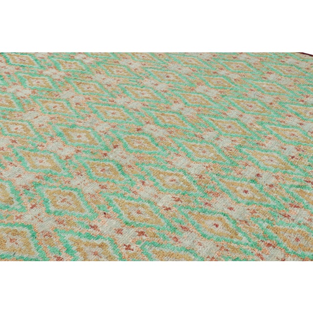 Hand-knotted in wool, this 8x10 contemporary rug from Rug & Kilim features geometric patterns in all over diamonds, or...