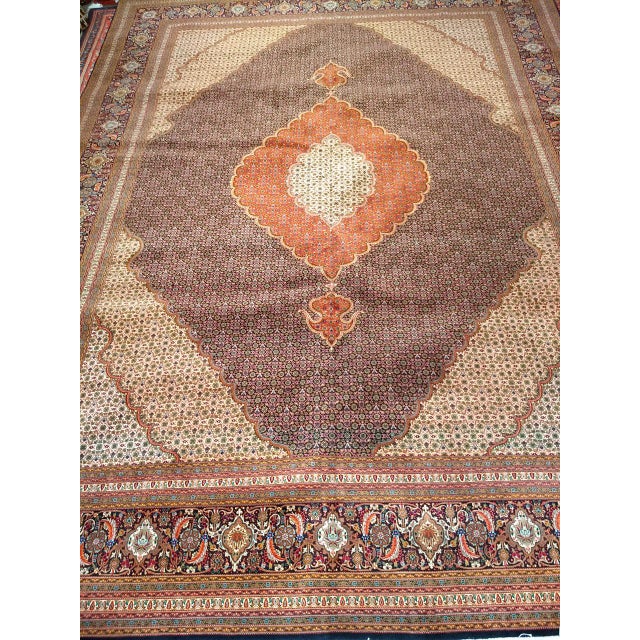 "Discover a breathtaking masterpiece of Persian artistry with this magnificent Mid-20th Century Vintage Persian Tabriz...