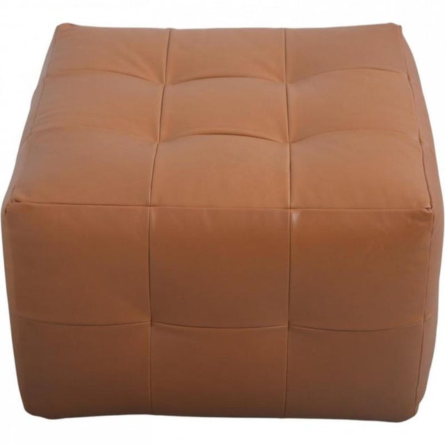 New ottoan of foam, upholstered in cognac anilin leather. Height: 40 / Width: 65 / Depth: 65 Cm.