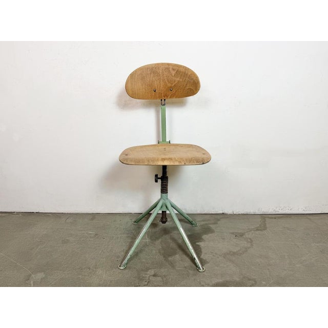 This industrial height adjustable, rotating chair was made in former Czechoslovakia during the 1950s.It features a green...