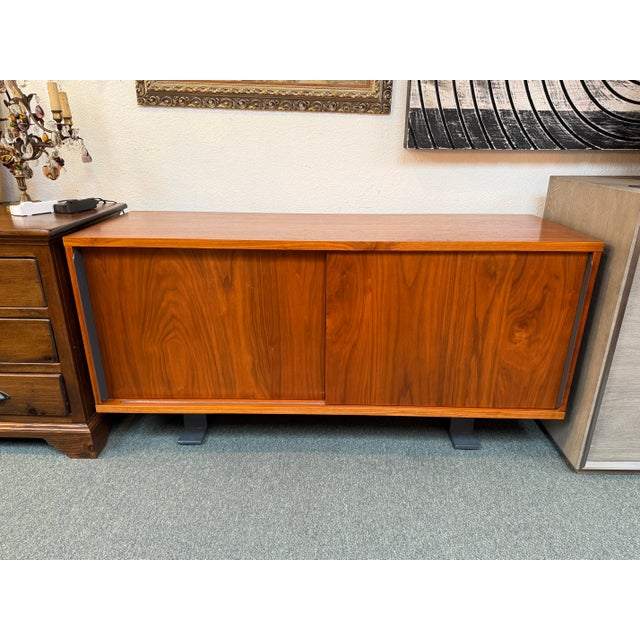 Design Plus Gallery presents the Saga Credenza from CB2. The credenza has two sliding door that open to interior shelving...