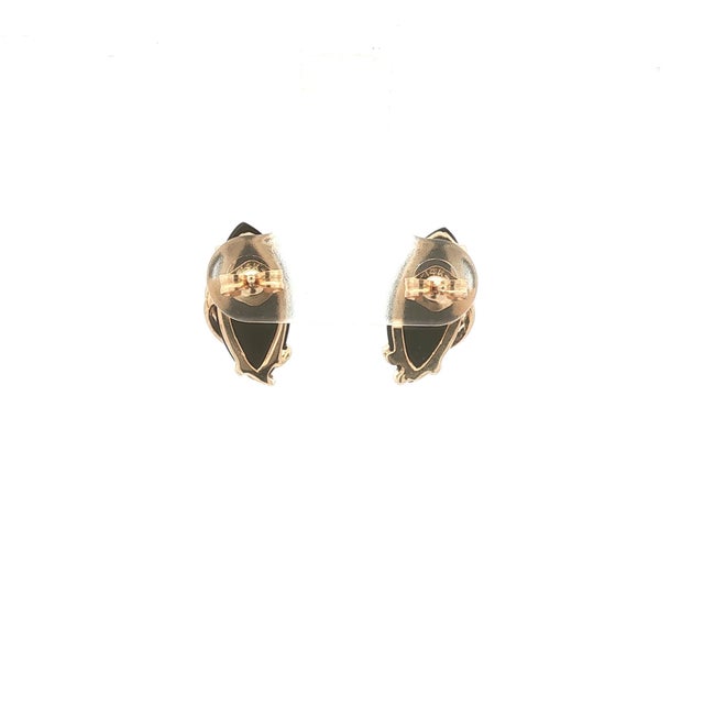 A pair of elegant stud earrings featuring marquise-cut black onyx stones. The stones are set in 14k gold, with a sleek,...