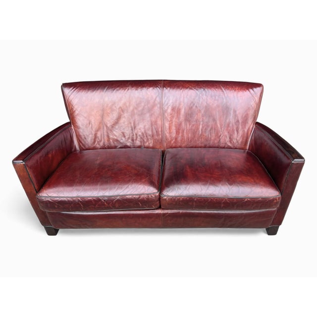 This elegant vintage leather sofa embodies timeless craftsmanship and refined, understated design. Upholstered in rich,...