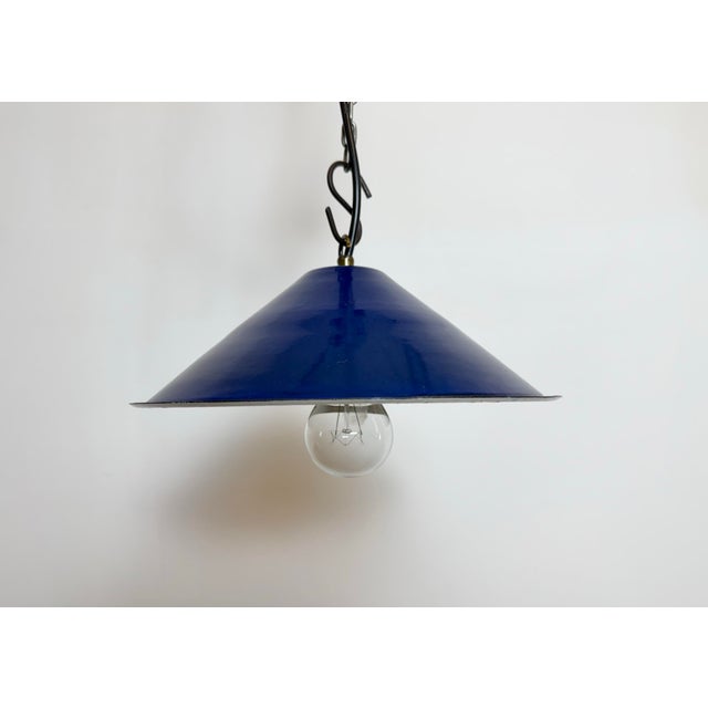 Industrial blue enamel factory pendant light made in United Kingdom during the 1950s . White enamel inside the shade....