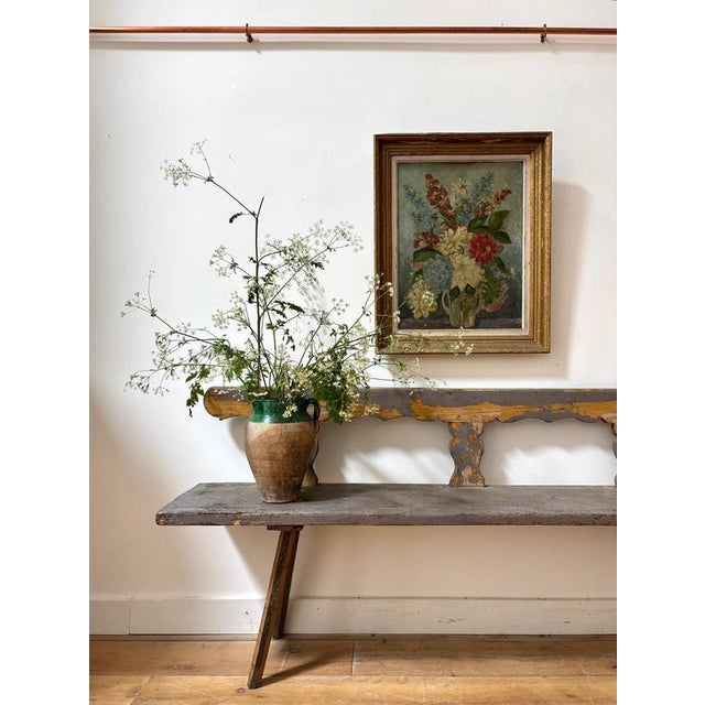 A sculpted Scandinavian bench in chippy purple paint. Such an unusual shade with green showing through. Splayed legs and...