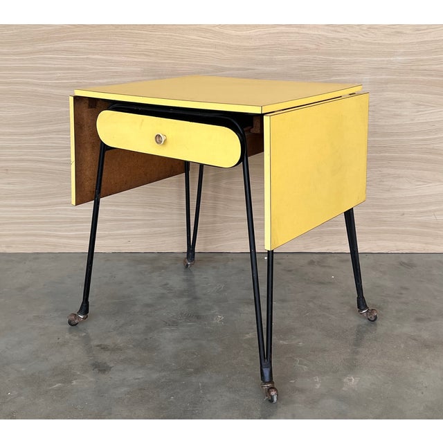 Yellow formica and black metal desk, Italian modernism, ca. 1960. Small desk from a hotel room with a matte black tubular...