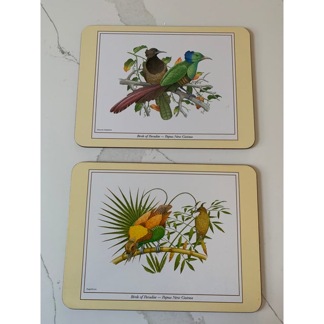 Offering a boxed set of luncheon sized hard board placemats, each depicting one of the exotic birds from this collection:...