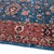 A deep peacock-blue field carrying an allover floral drawn in the Persian Tabriz manner: a pair of saffron-and-coral saz...