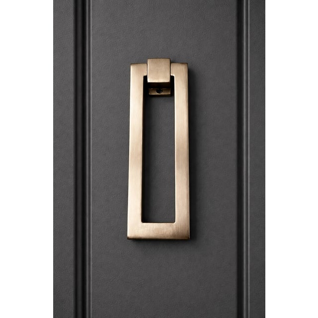 Sleek brushed chrome door knocker with a contemporary rectangular design and clean architectural lines. This modern piece...
