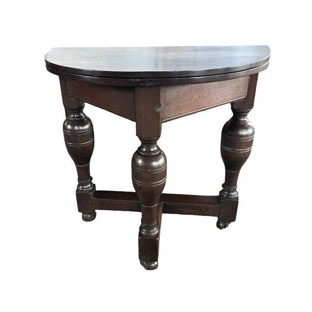 Gateleg / Drop-leaf table hand-made in the Netherlands in the early 1700s using oak. The table has a round shape when...
