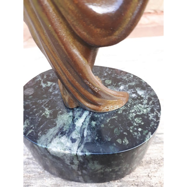 Elegant bronze sculpture with brown patina with green nuances representing a naked woman in drapery. Signed on the back...