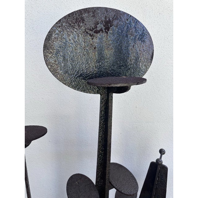 This abstract iron sculpture is a striking piece of art that showcases a unique blend of brutalist and mid-century...